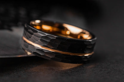 Black and gold ring on a dark surface