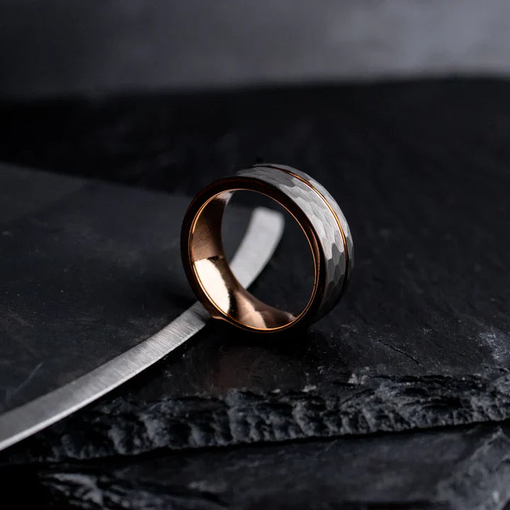 Rustic hammered gray tungsten carbide with rose gold coated inlay and interior