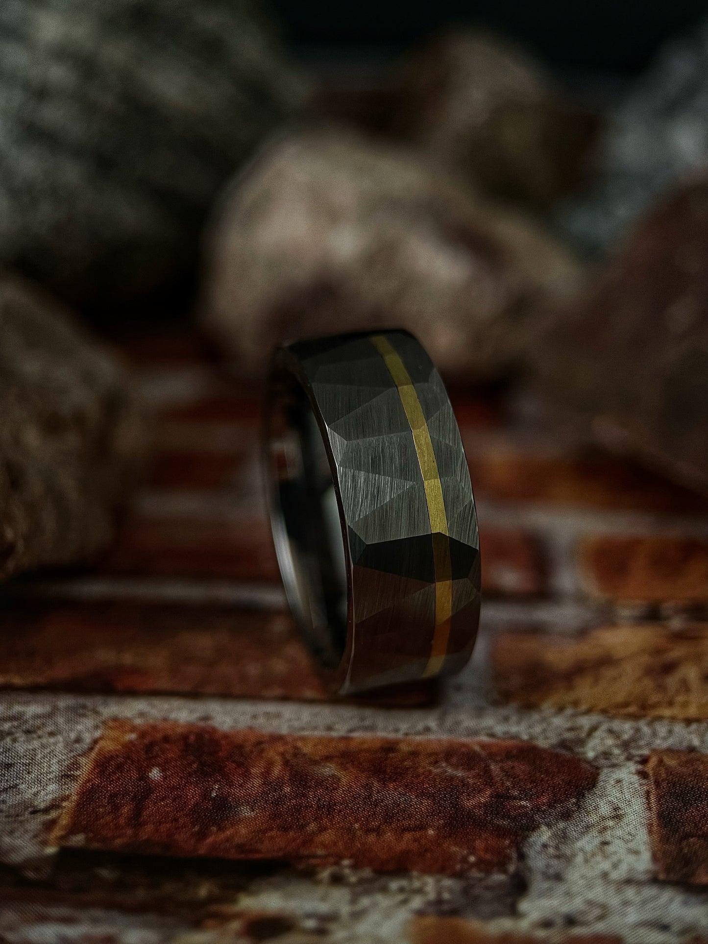 The Chimera handcrafted raw tungsten ring featuring a solid 14k gold inlay.