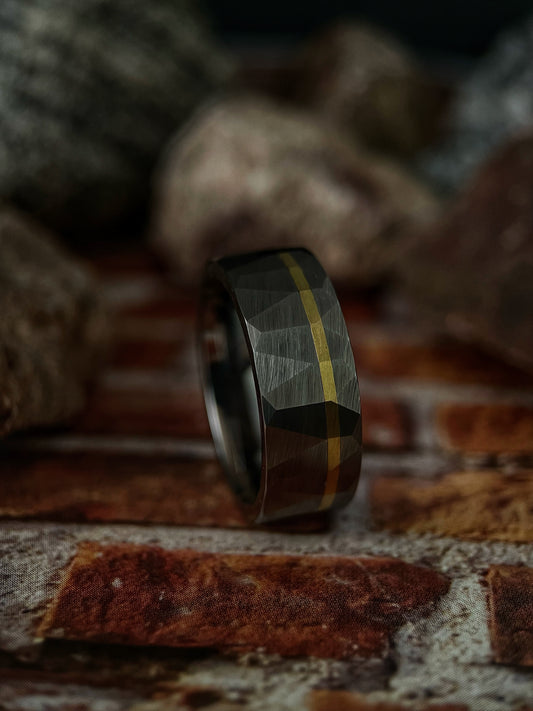 The Chimera handcrafted raw tungsten ring featuring a solid 14k gold inlay.