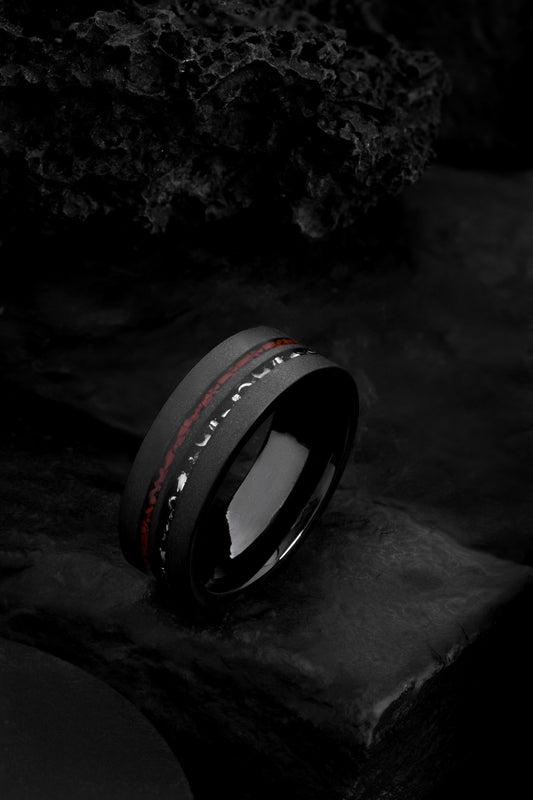 The Ares sandblasted black tungsten ring featuring dual offset inlays of T-Rex bone and meteorite.