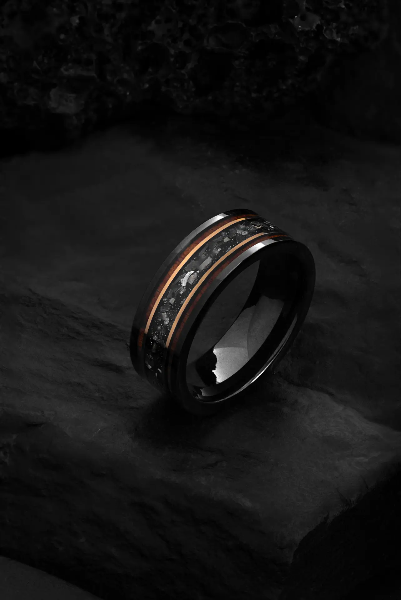 The Draco black tungsten ring featuring a grey crushed meteorite inlay and silver-tone interior.