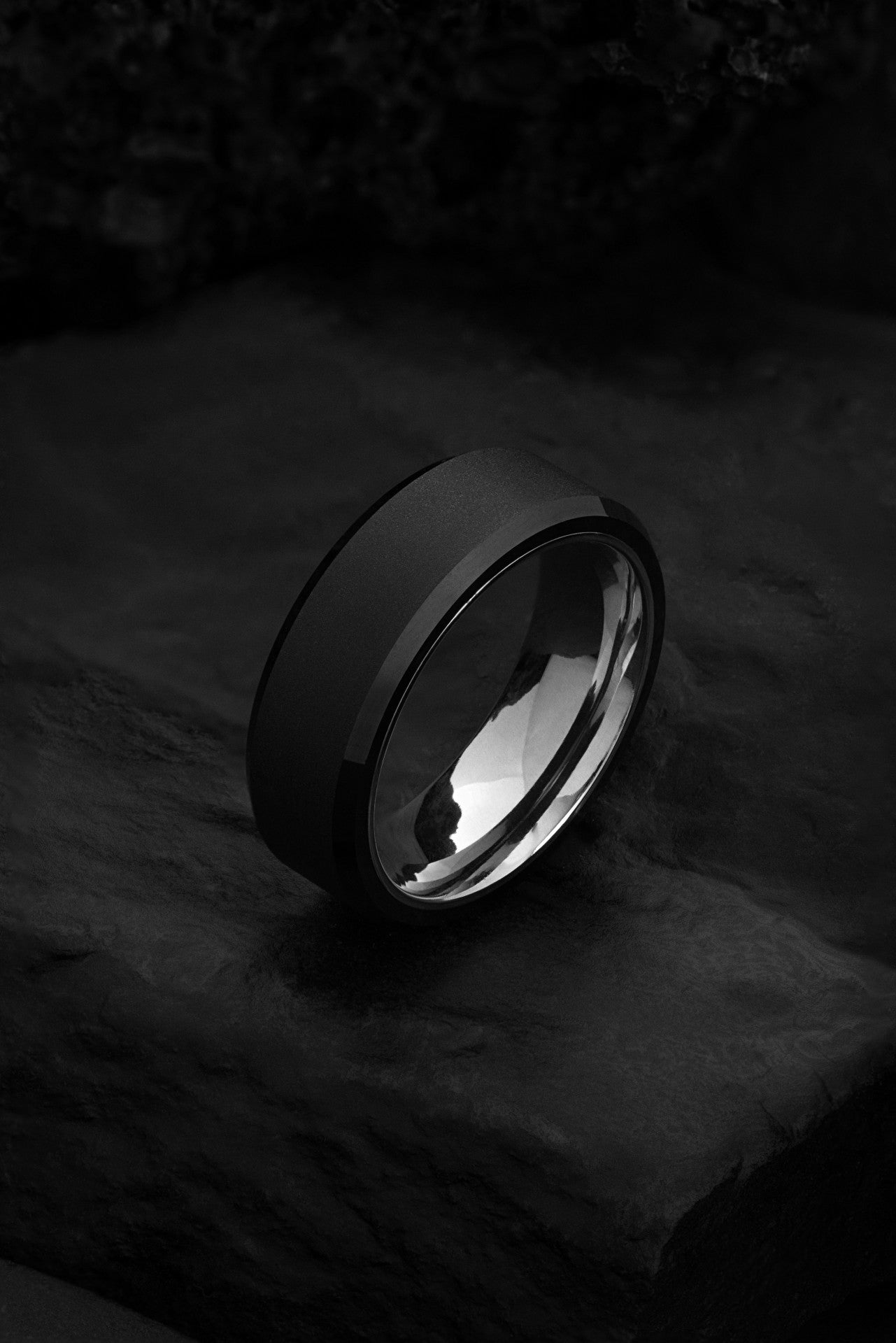 The Zephyrus 6mm black tungsten ring with brushed finish and polished beveled edges.