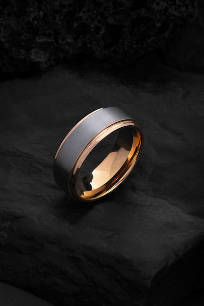 The Pegasus brushed gunmetal tungsten ring featuring a polished rose gold interior.