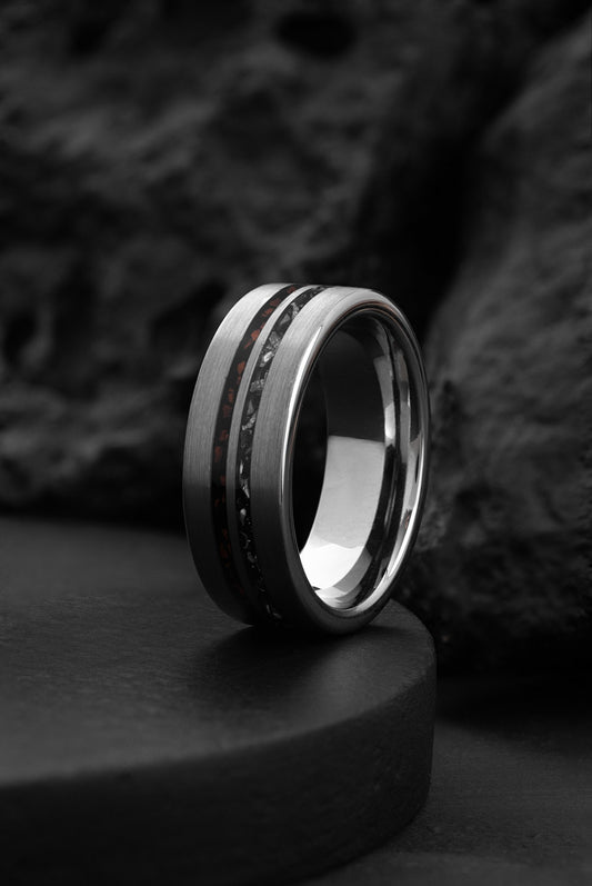 The Celestial Legacy tungsten ring featuring a crushed red T-Rex bone and meteorite inlay.
