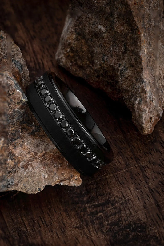 Matte black tungsten ring featuring a row of jet black stones set in a channel.