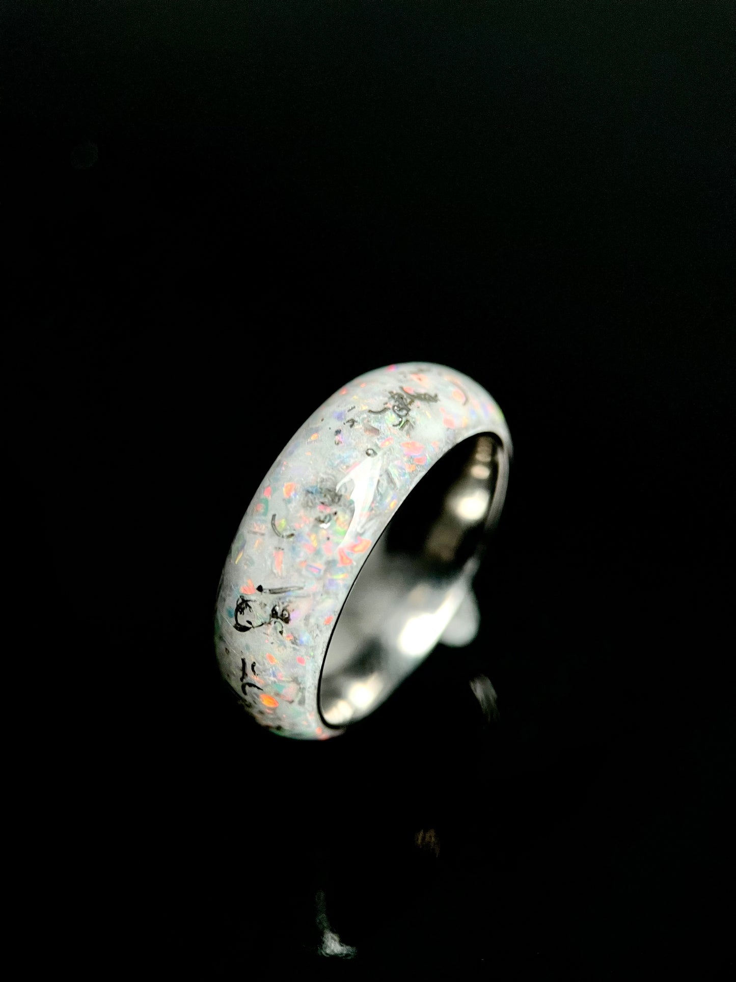 Man wearing The Phobos unique wedding band with meteorite and opal on ring finger.