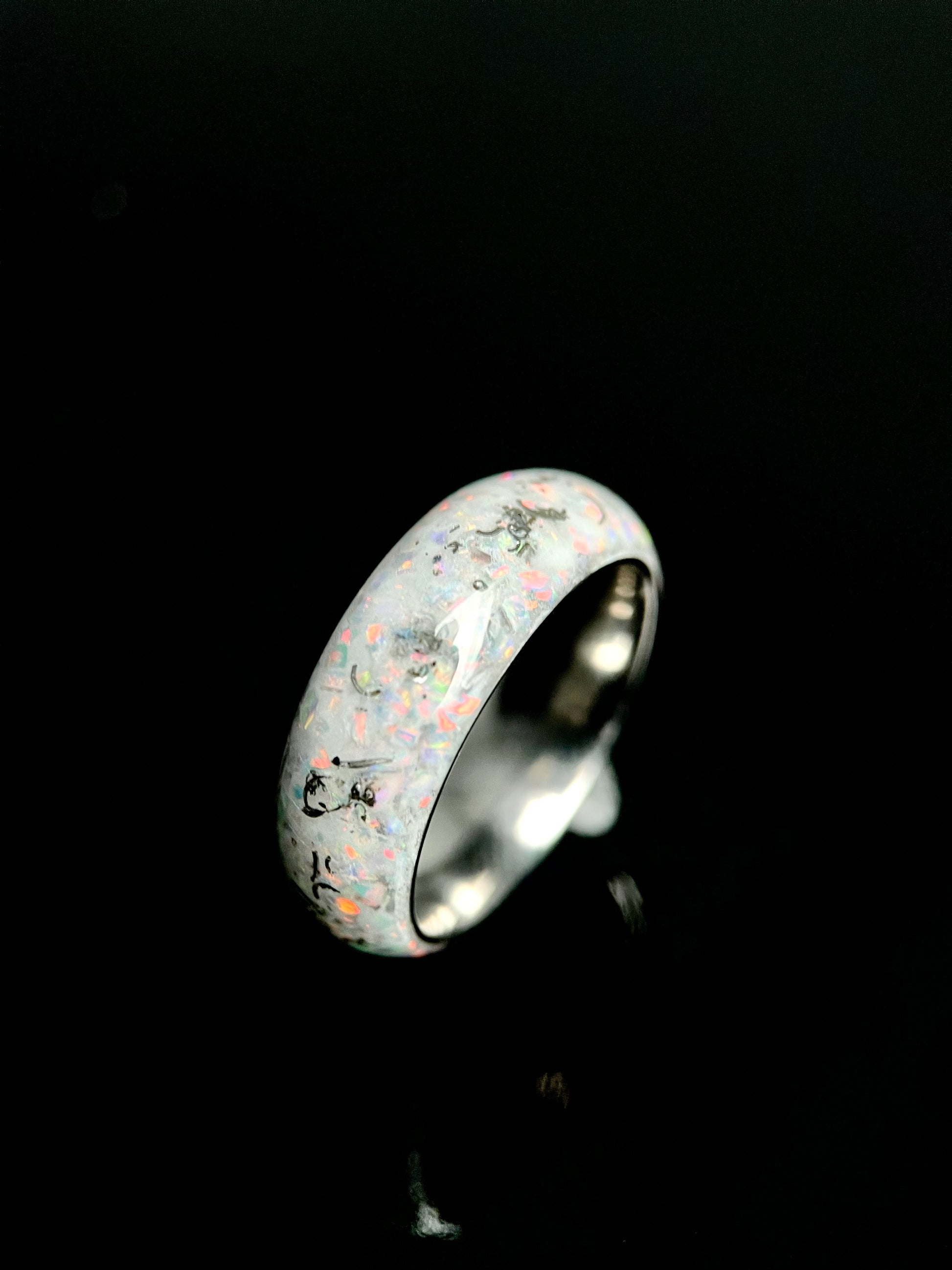 Man wearing The Phobos unique wedding band with meteorite and opal on ring finger.