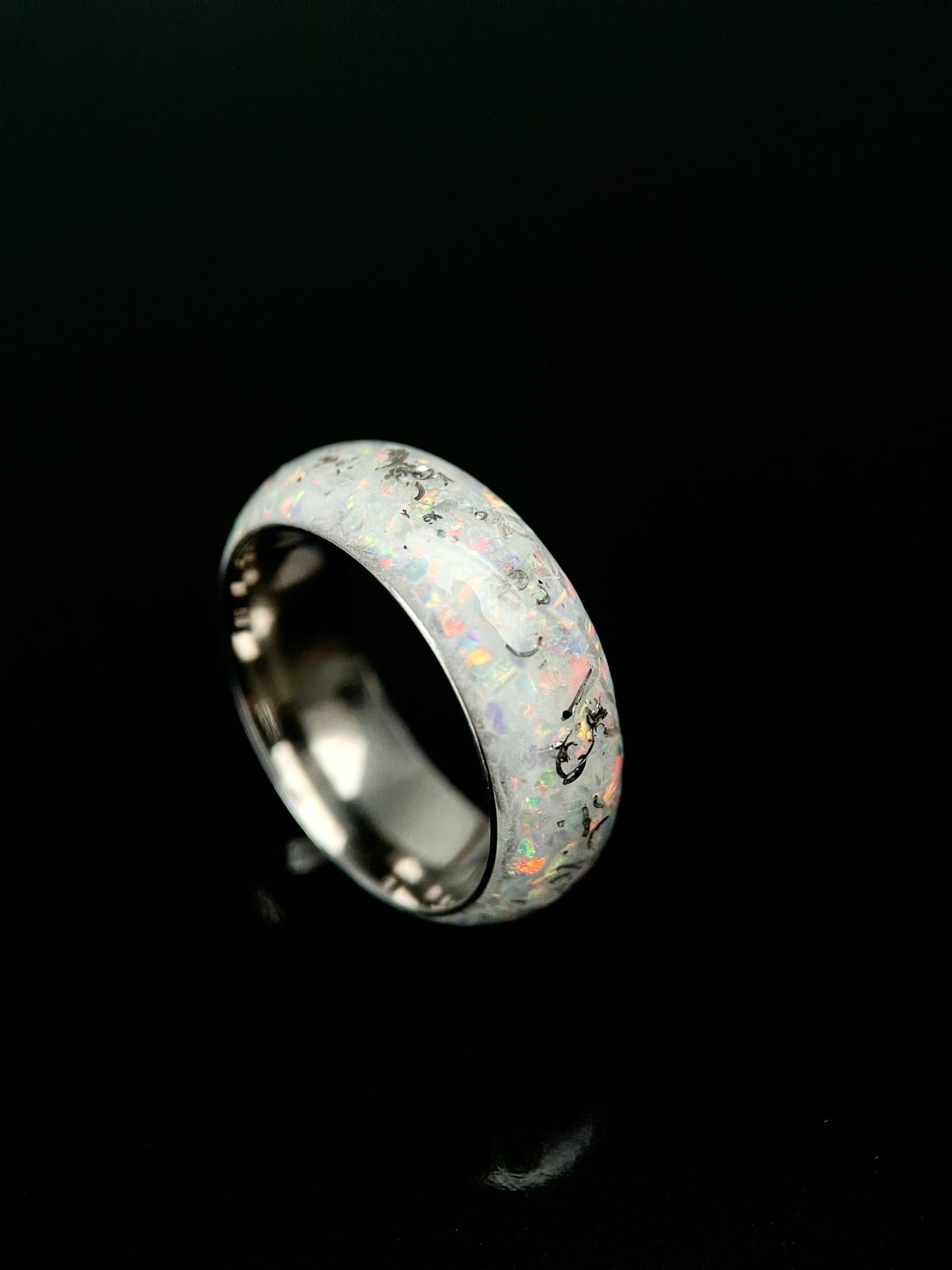 The Phobos Mens Opal Ring featuring crushed Muonionalusta meteorite and glow-in-the-dark inlay on a black band.