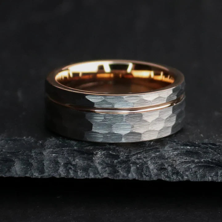 Rustic hammered gray tungsten carbide with rose gold coated inlay and interior