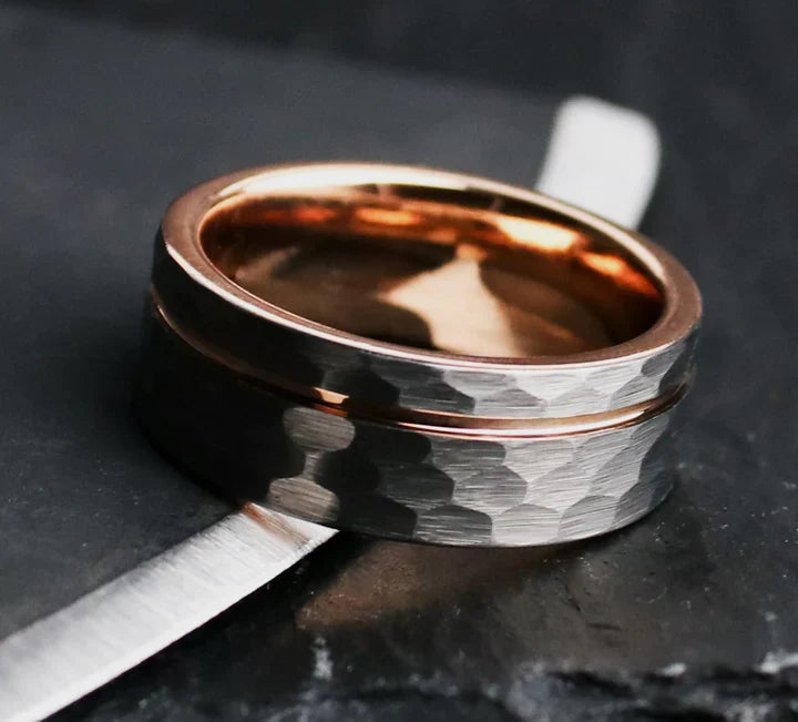 Rustic hammered gray tungsten carbide with rose gold coated inlay and interior