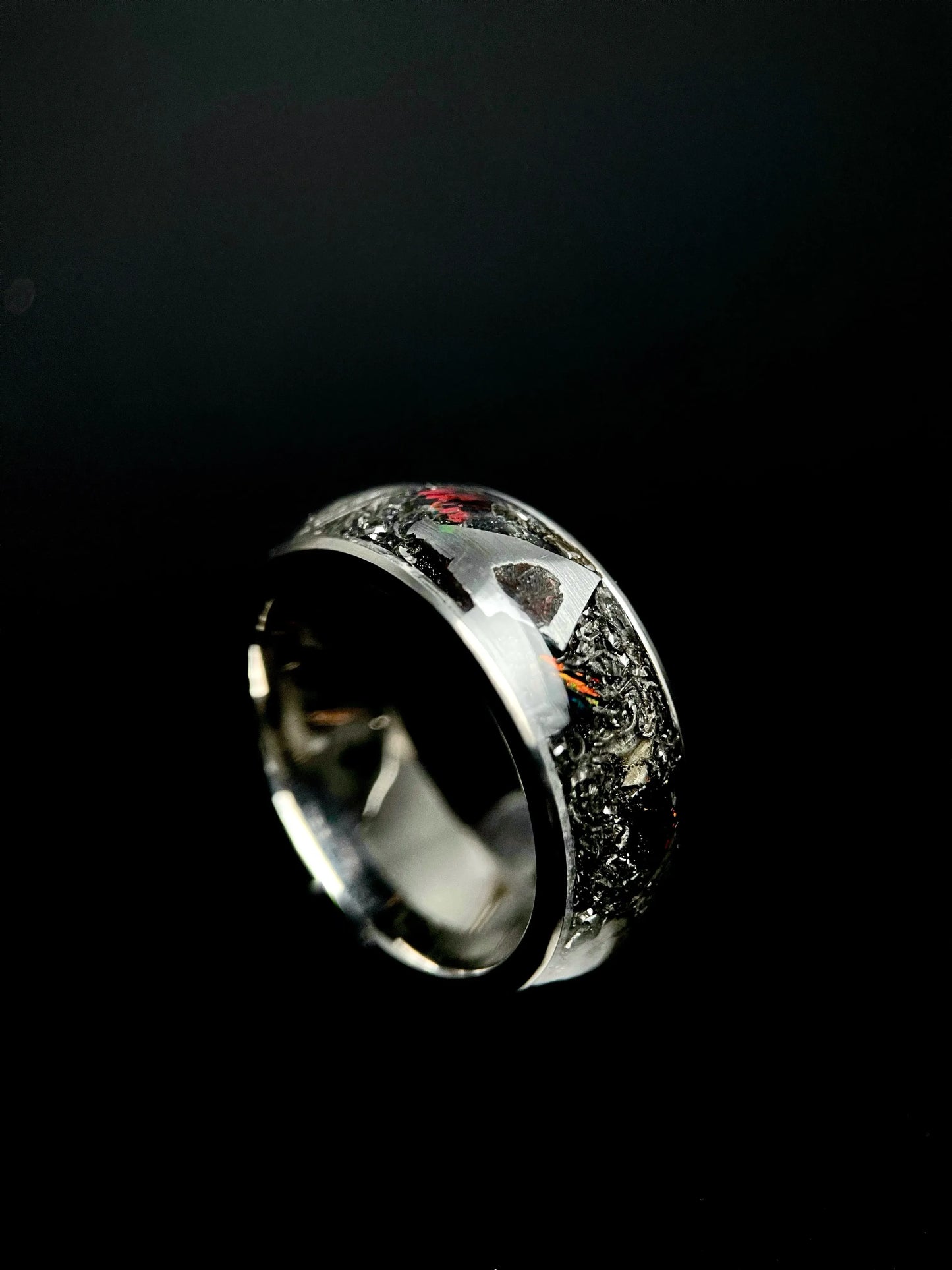 Regalia Rings Boreas titanium wedding ring featuring meteorite inlay and fire opal accents, showcasing a unique, luxurious design.