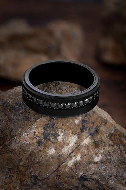 Matte black tungsten ring named The Achilles by Regalia Rings, featuring a sleek, durable design of strength and modern style.