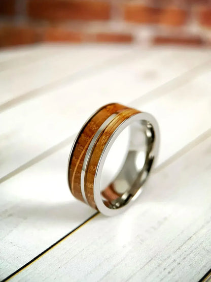 Regalia Rings The Asclepius whiskey barrel and titanium healing ring, featuring detailed craftsmanship and symbolic design.