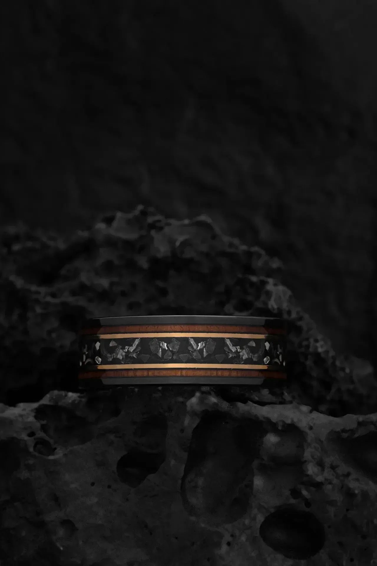 Black tungsten ring with meteorite chunks from Regalia Rings, showcasing a bold, textured design with sleek and rugged details.