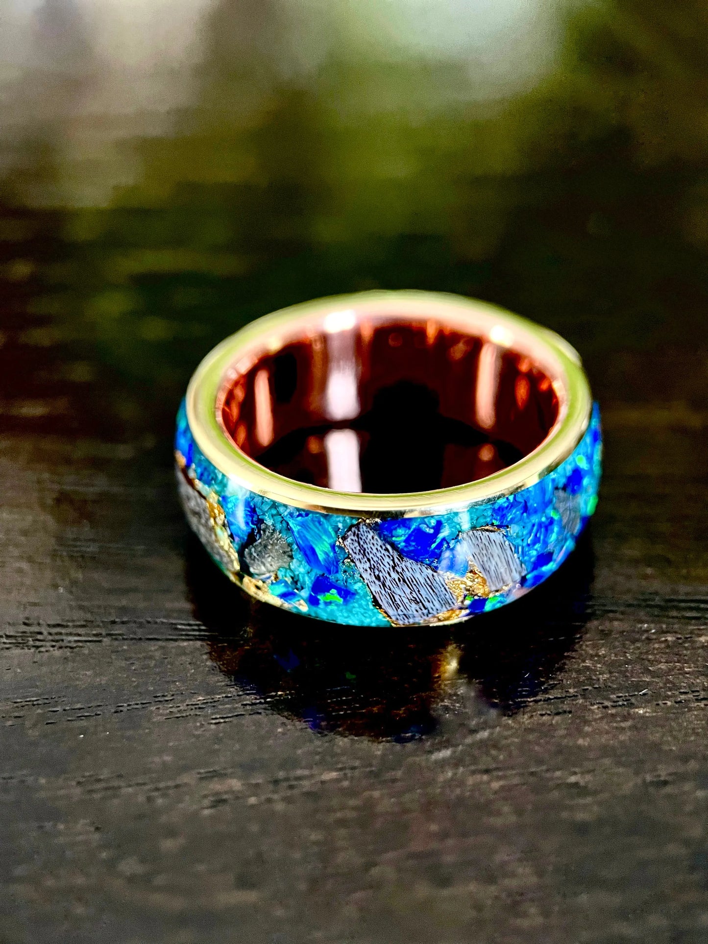 Regalia Rings The Glaucus ring featuring meteorite, opal, and dino bone in a detailed, artistic design.
