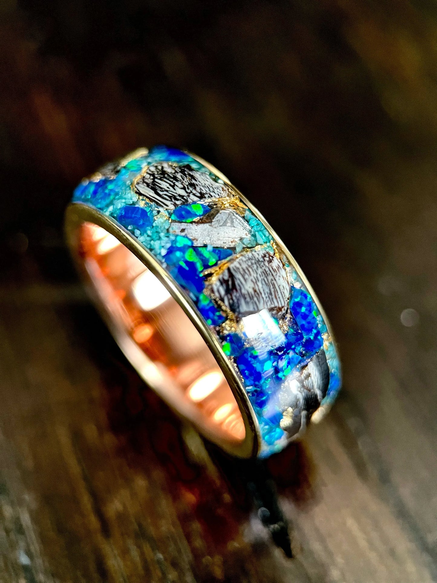 Regalia Rings The Glaucus meteorite, opal, and dino bone ring showcasing a unique, handcrafted jewelry design with mixed materials.