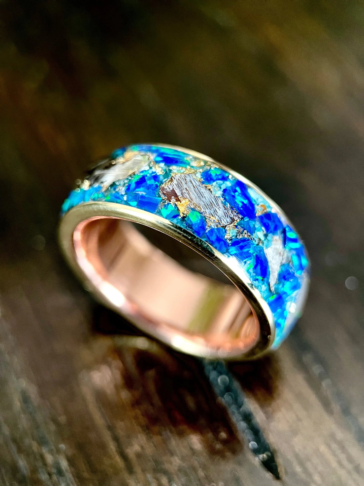 Regalia Rings The Glaucus ring featuring meteorite, opal, and dino bone inlay with a sleek, handcrafted design.