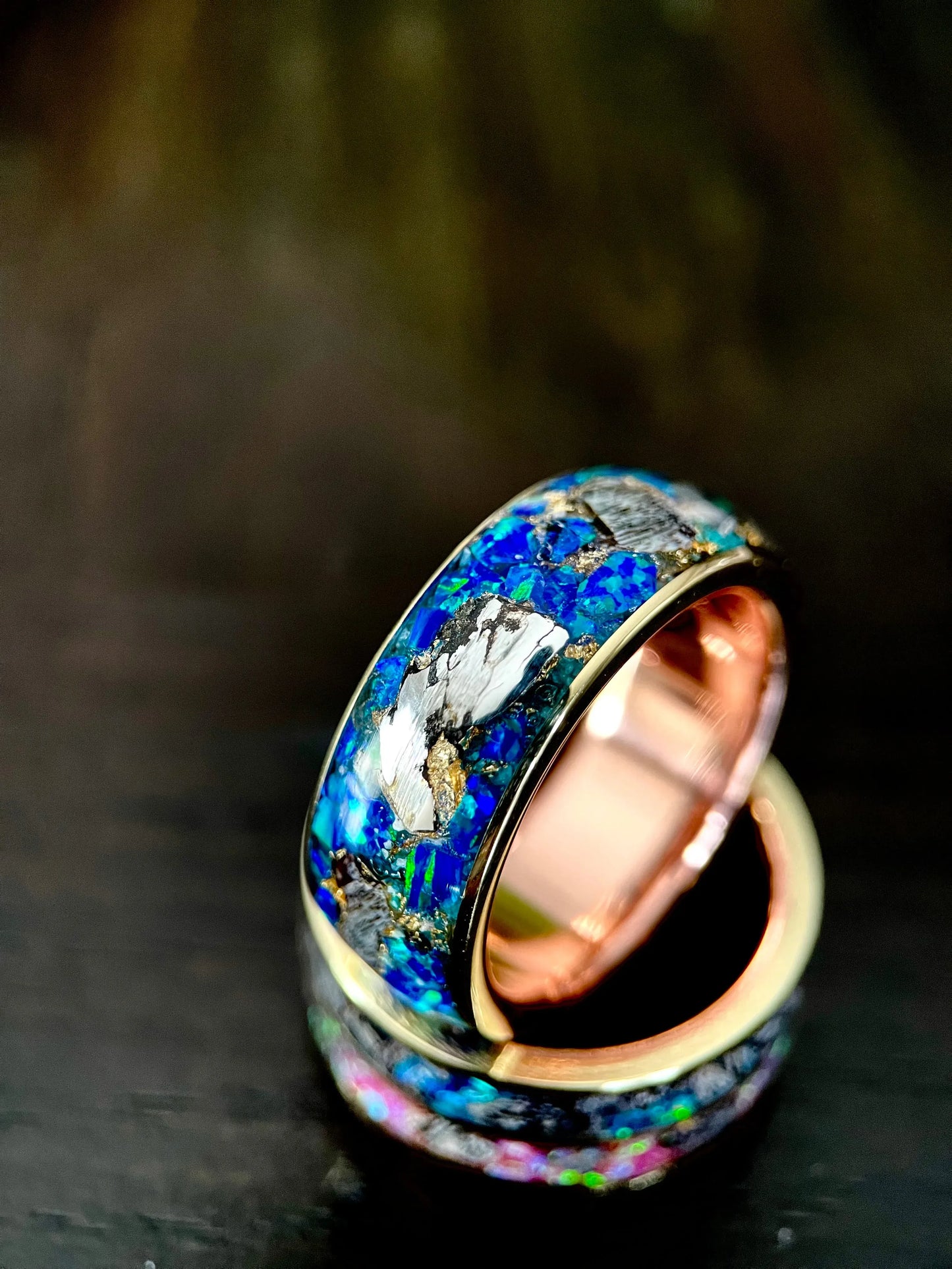 Close-up of The Glaucus ring by Regalia Rings featuring meteorite, opal, and dino bone in a detailed, handcrafted design.