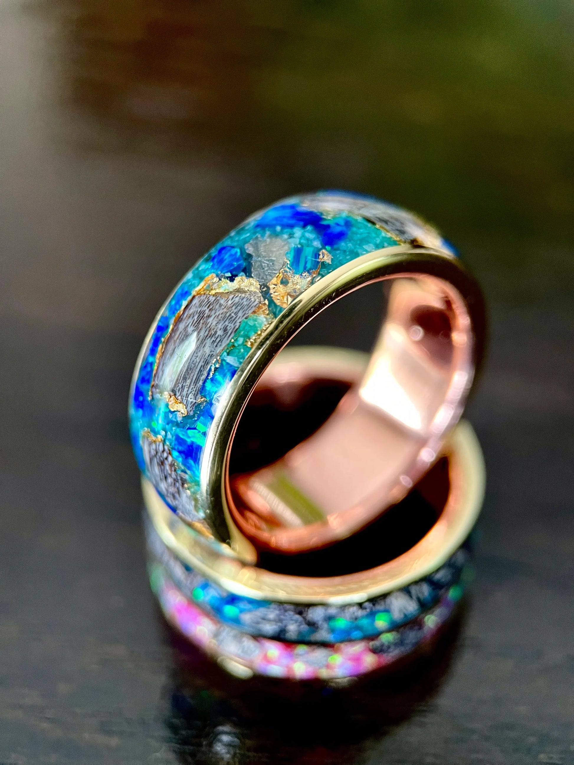 Regalia Rings The Glaucus ring with crushed opal, dinosaur bone, and meteorite inlay framed by brass liners.