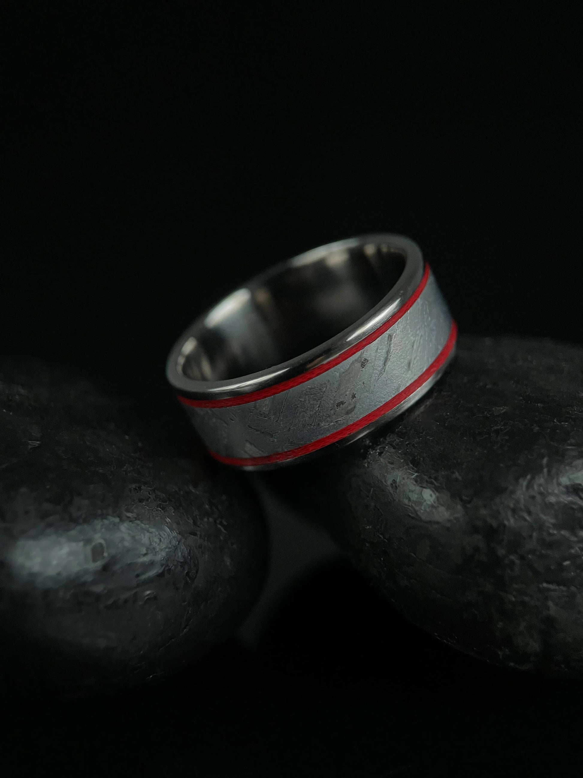 The Orion titanium Grade 5 ring featuring Muonionalusta meteorite inlay, crafted by Regalia Rings, displayed on a white background.