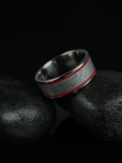 The Orion titanium Grade 5 ring featuring Muonionalusta meteorite inlay, crafted by Regalia Rings, displayed on a white background.