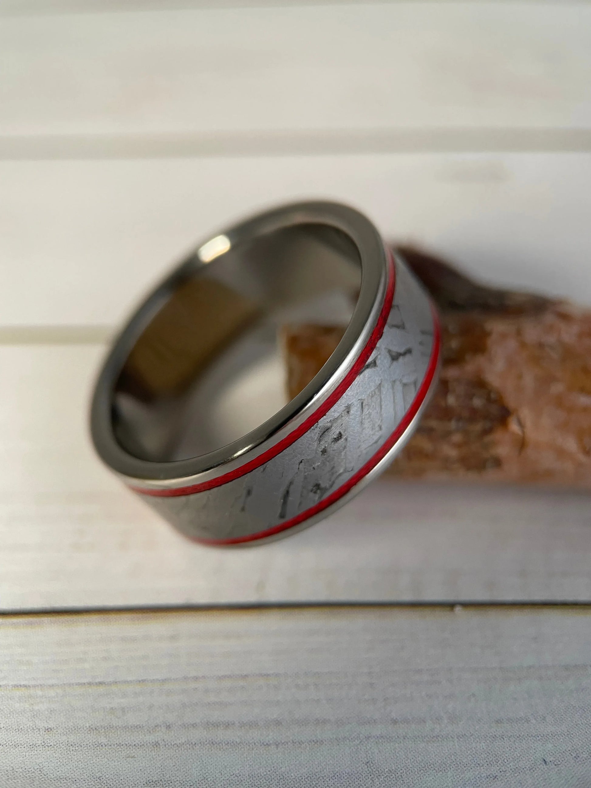 Titanium Grade 5 ring with Muonionalusta meteorite inlay, featuring a sleek, modern design by Regalia Rings.