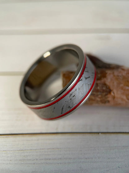 Titanium Grade 5 ring with Muonionalusta meteorite inlay, featuring a sleek, modern design by Regalia Rings.