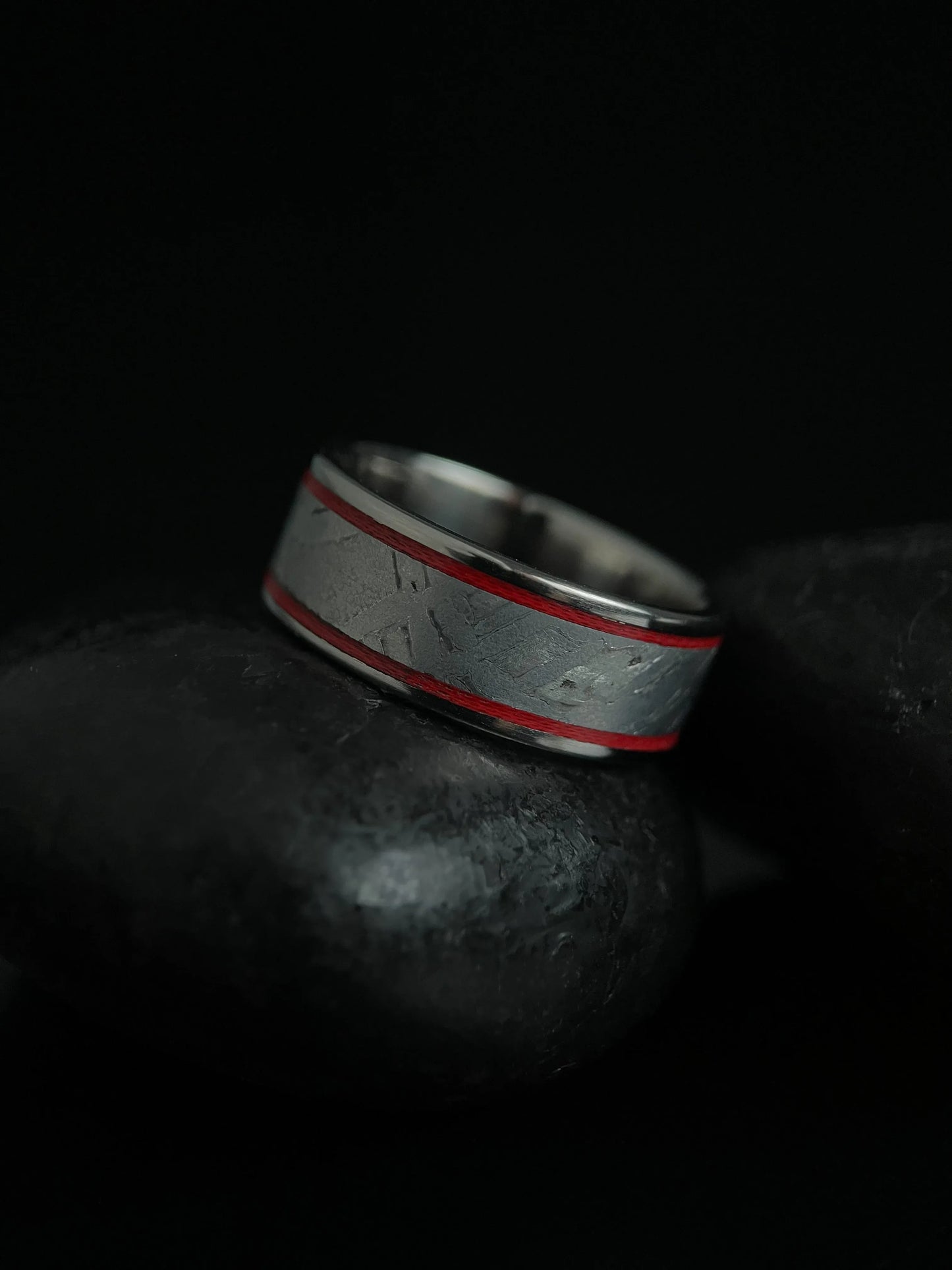 Silver titanium Grade 5 ring featuring a Muonionalusta meteorite fragment with a sleek, modern design by Regalia Rings.