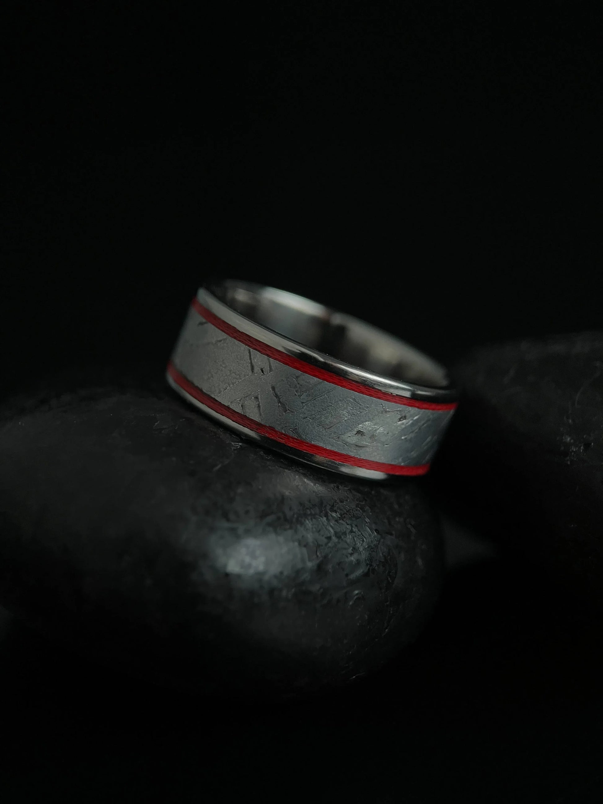 Silver titanium Grade 5 ring featuring a Muonionalusta meteorite fragment with a sleek, modern design by Regalia Rings.