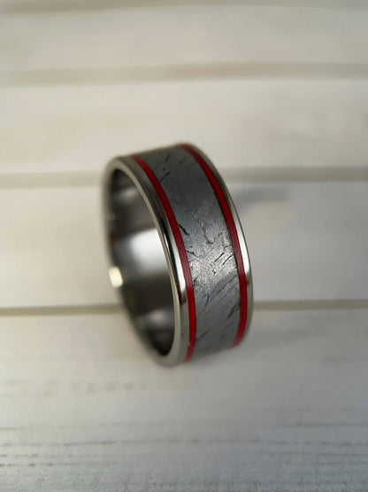 The Orion titanium Grade 5 ring featuring Muonionalusta meteorite inlay, showcasing a sleek, modern design with a polished finish.