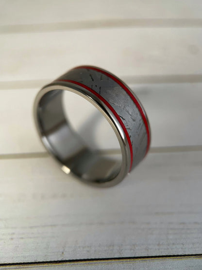 The Orion Muonionalusta meteorite and titanium Grade 5 ring by Regalia Rings, showcasing a sleek band with meteorite inlay and polished finish.