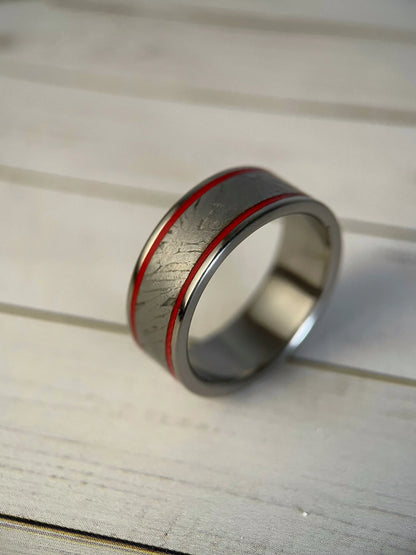Close-up of Regalia Rings' The Orion titanium Grade 5 ring featuring Muonionalusta meteorite inlay, showcasing a sleek, modern design.