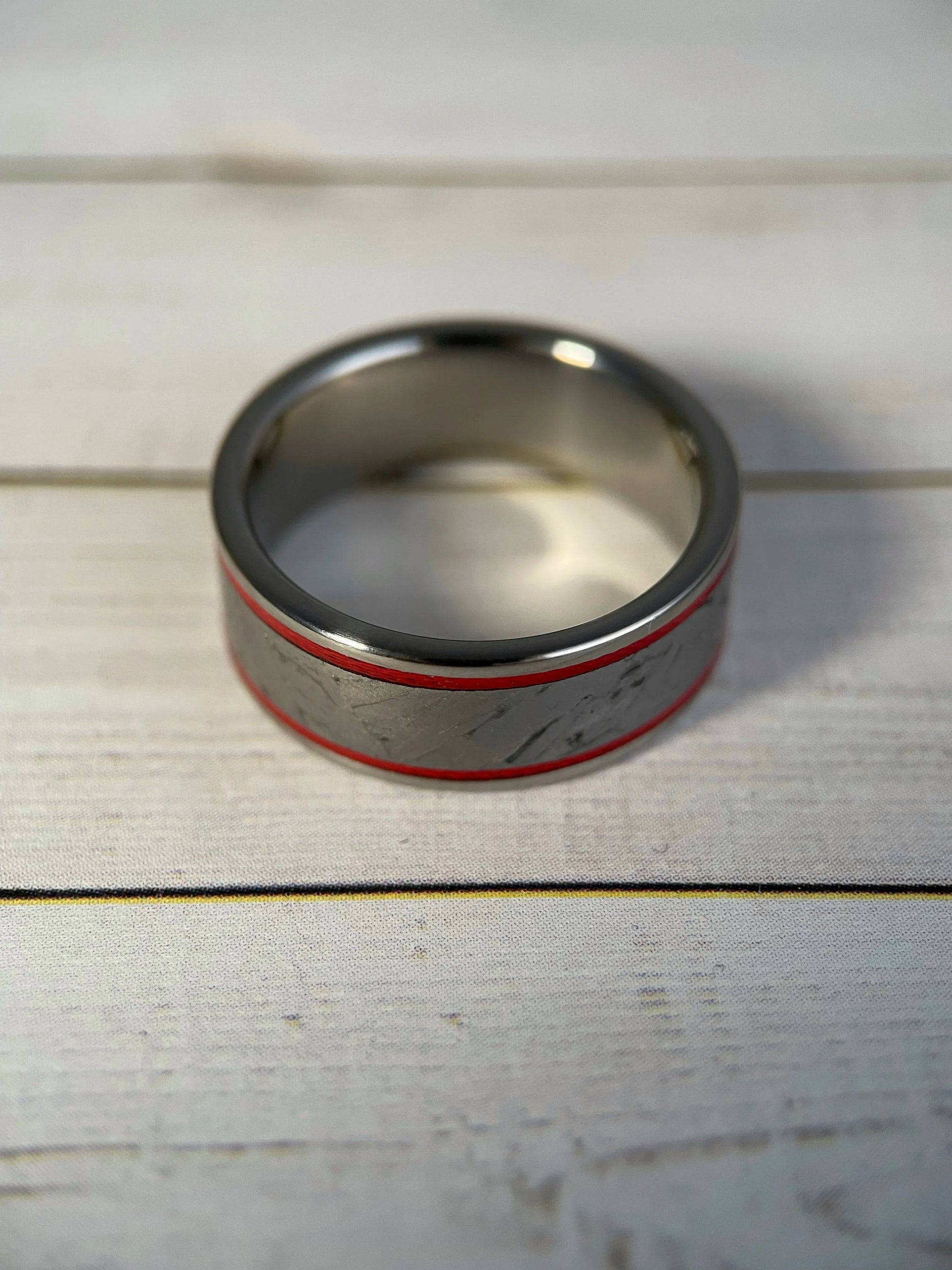 The Orion ring by Regalia Rings featuring Muonionalusta meteorite and titanium Grade 5 band on a white background.