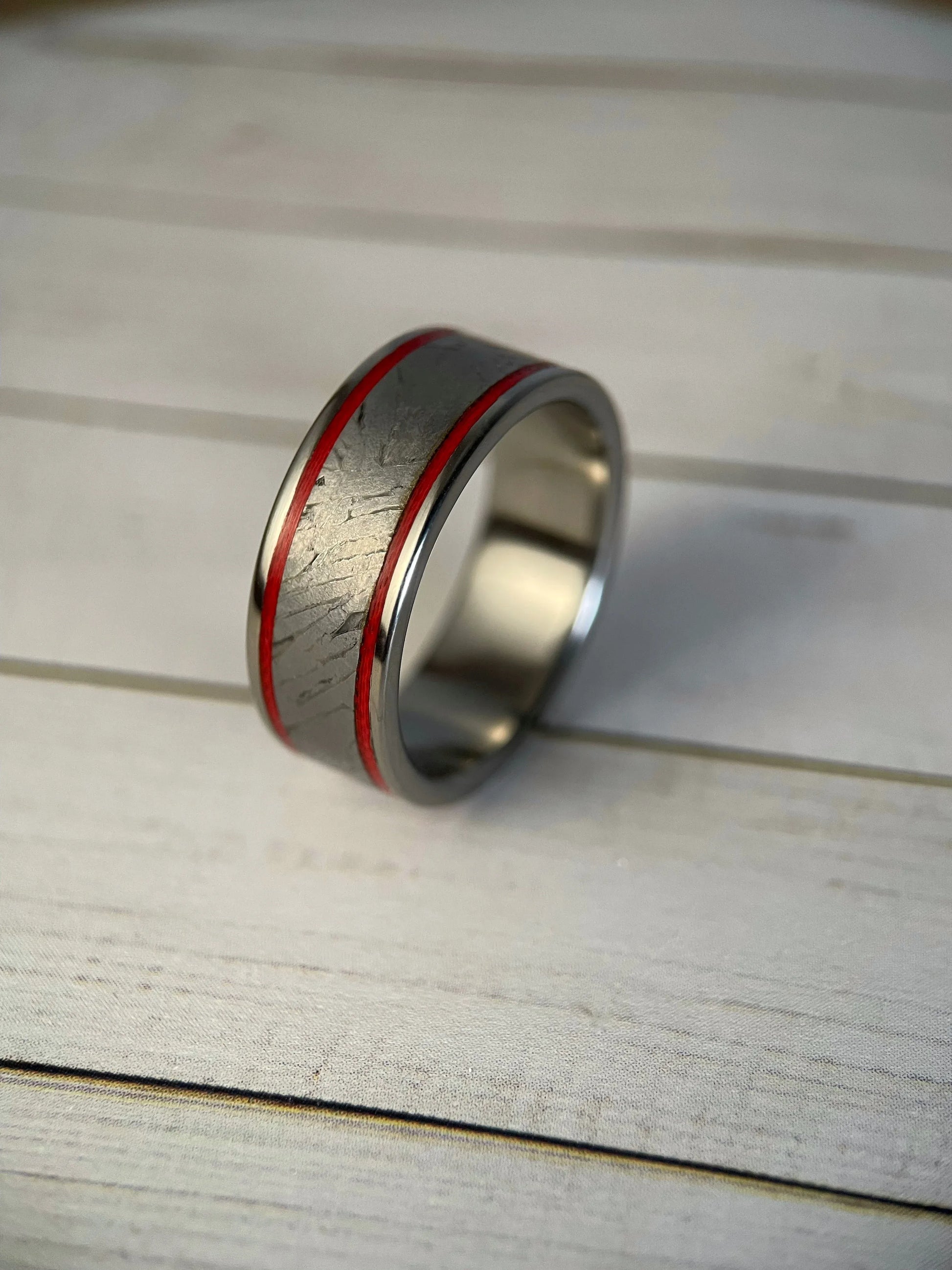 Close-up of The Orion titanium ring by Regalia Rings featuring Muonionalusta meteorite inlaid design and Grade 5 titanium band