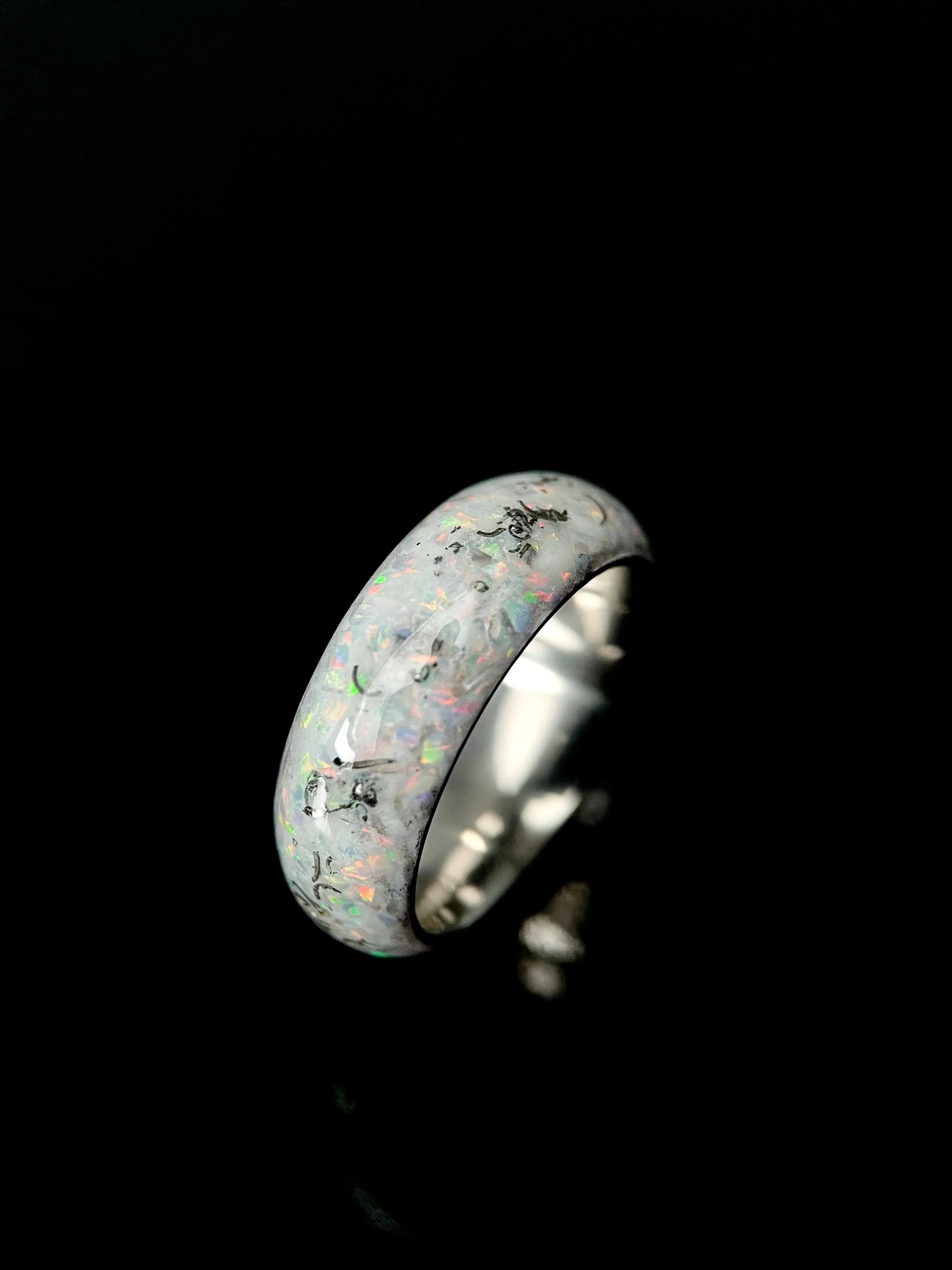 Regalia Rings The Phobos glow-in-the-dark ring with meteorite and luminescent blue opal inlay against a black background