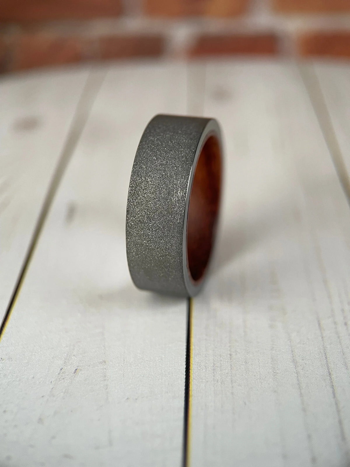 Regalia Rings The Prometheus Redwood Liner and Sandblasted Tungsten Band showing detailed wood grain and matte finish
