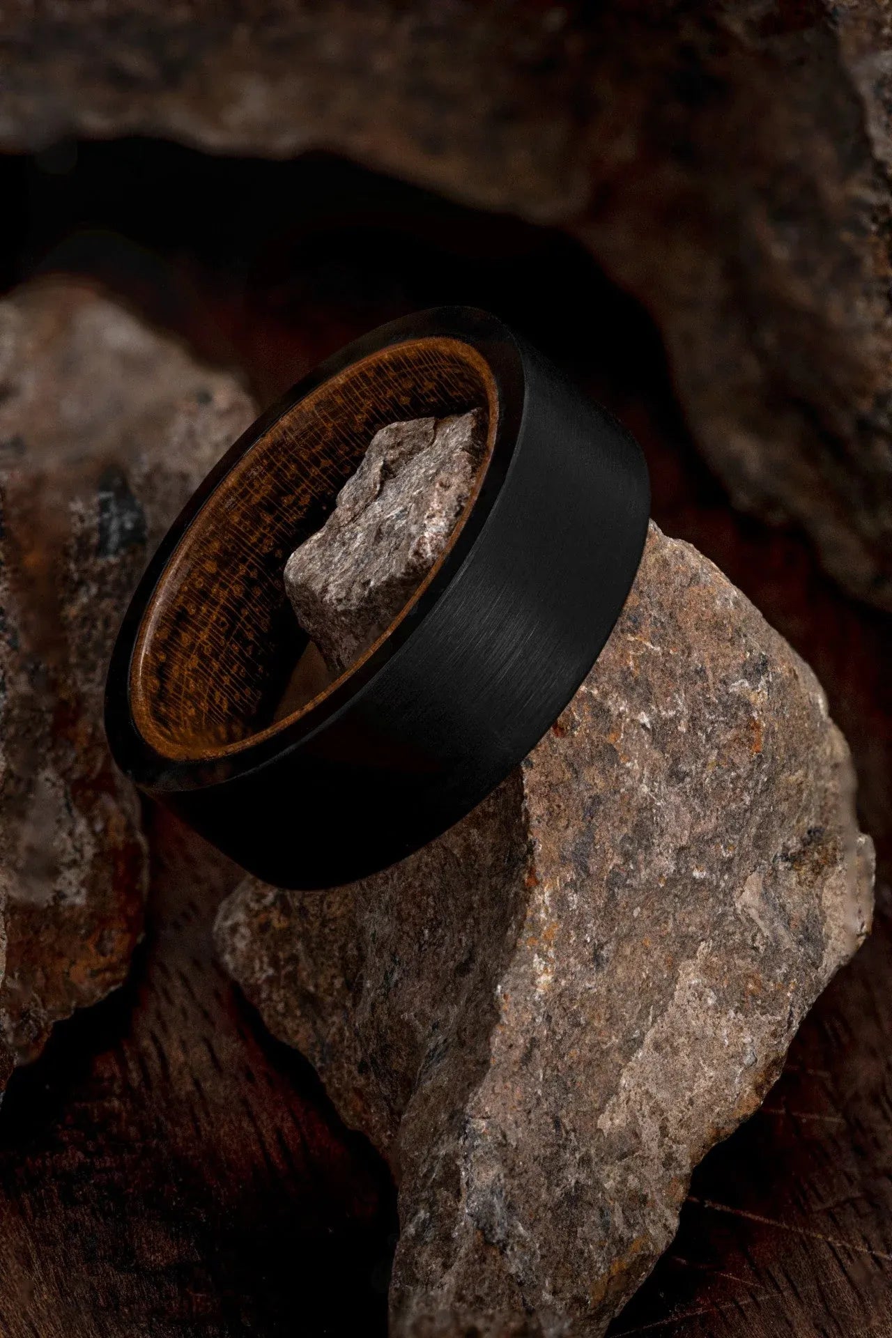 Regalia Rings Rigel’s Legacy red wood and black tungsten ring showing smooth wood grain and sleek black tungsten band design