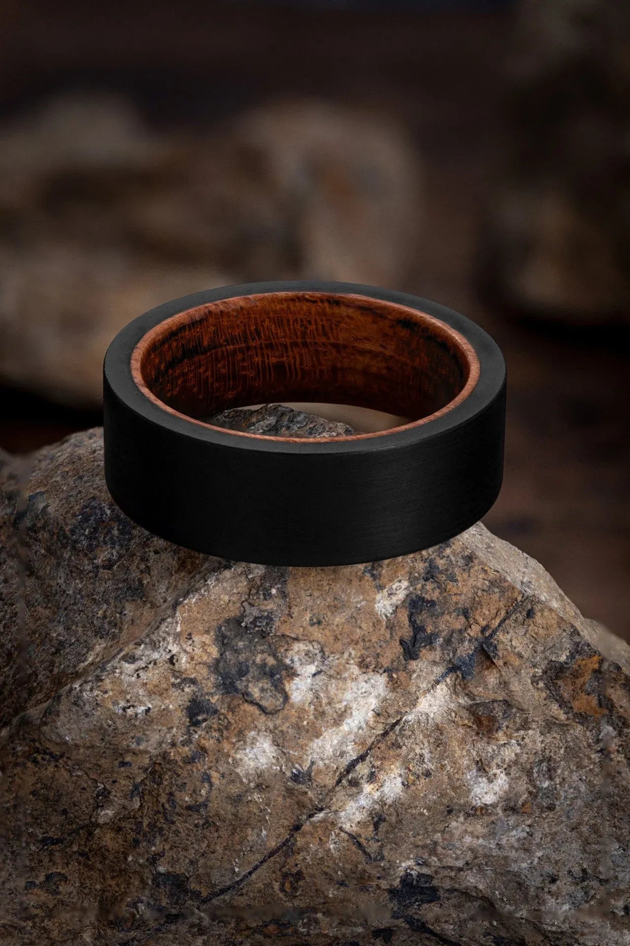 Regalia Rings Rigel’s Legacy red wood and black tungsten ring with polished finish and sleek design.