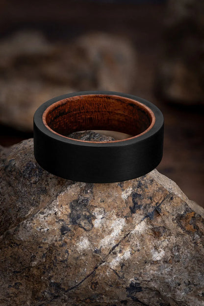 Regalia Rings Rigel’s Legacy red wood and black tungsten ring with polished finish and sleek design.