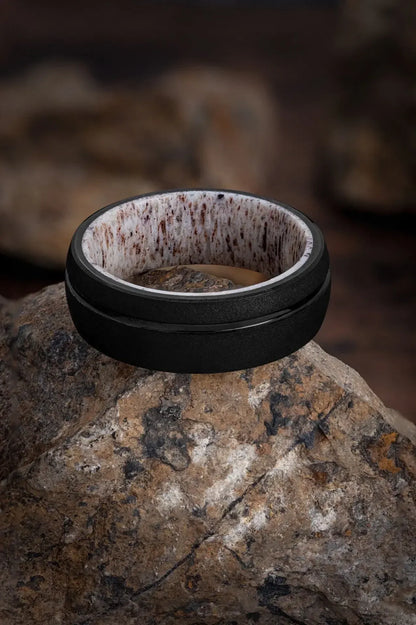 Black tungsten ring with deer antler inlay from Regalia Rings' The Zeus collection, showcasing a sleek and rugged design.